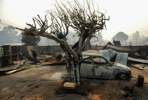 Residents survey damaged buildings in southern Chile as authorities battle wildfires