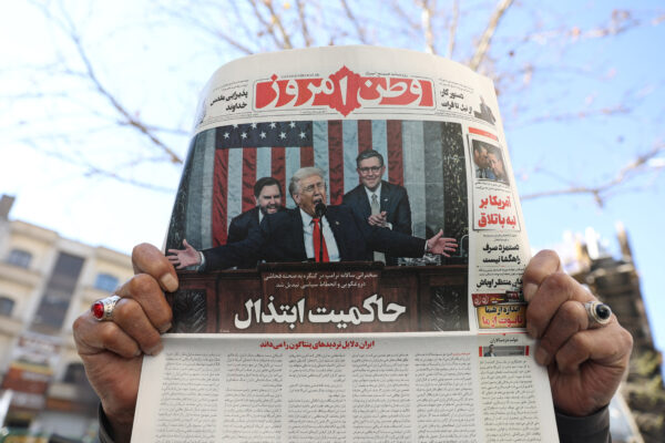 Man shows newspaper with front-page photo of U.S. President Trump, in Tehran