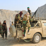 Taliban soldiers carry rocket launcher in a vehicle near Torkham border