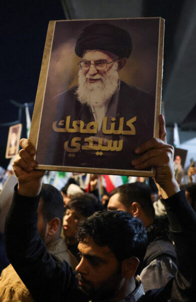 Supporters of Iraqi Shi’ite armed groups gather near the entrance of Baghdad’s Green Zone to show support for Iran, in Baghdad
