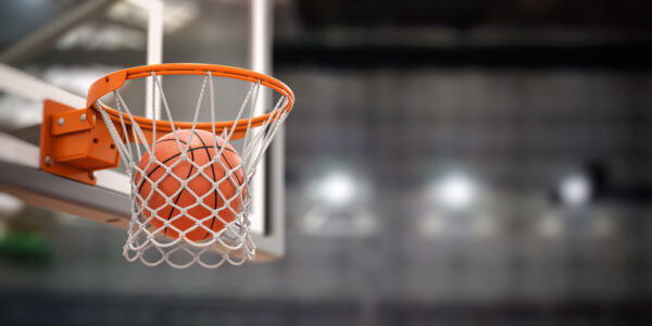 Basketball ball scoring the winning points on basketball net ho