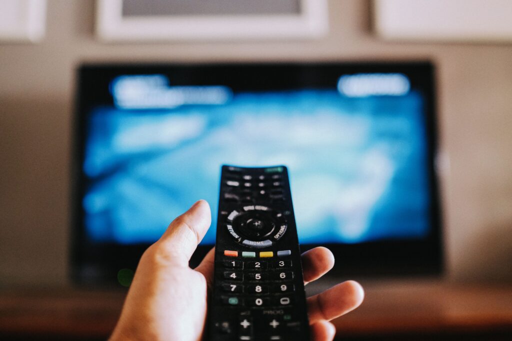 Closeup of the hand holding the remote control.