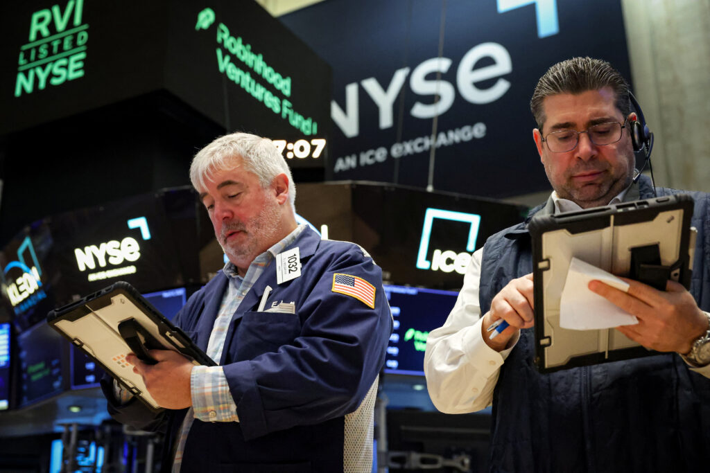 Traders work on the floor of the NYSE in New York