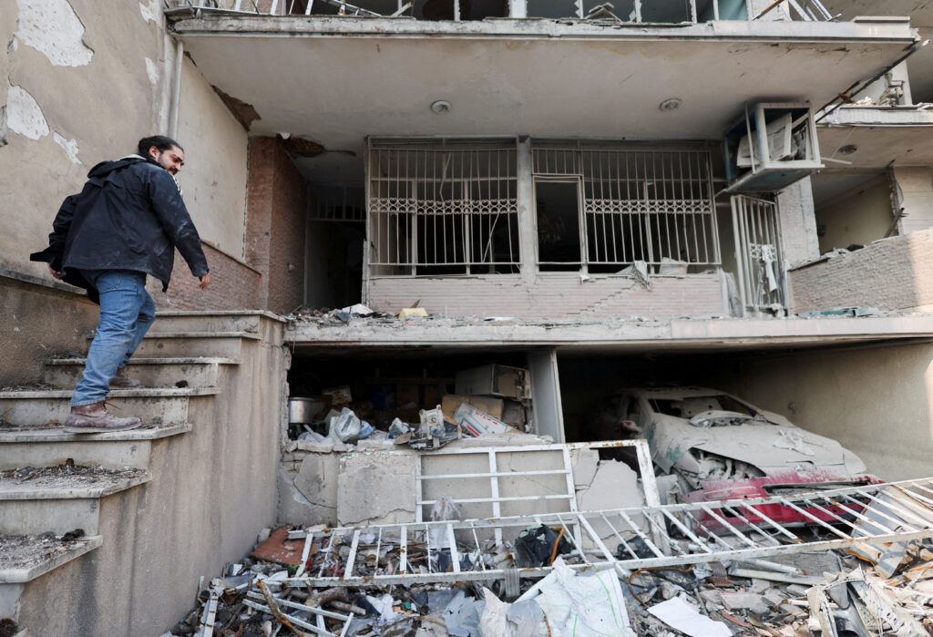 An Iranian man, Parsa, goes into his house, which was destroyed by a strike, amid the U.S.-Israeli conflict with Iran, in Tehran