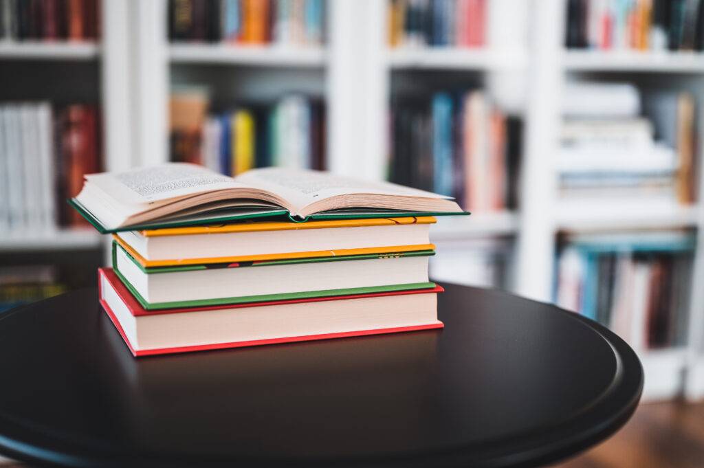 a-stack-of-books-on-a-black-table-library-in-the-2026-03-26-08-00-47-utc
