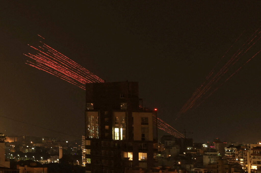 Streaks of tracer fire illuminate the sky as people celebrate the ceasefire in Beirut