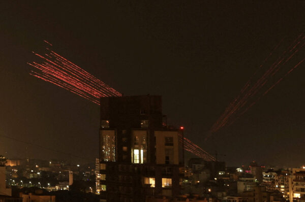 Streaks of tracer fire illuminate the sky as people celebrate the ceasefire in Beirut