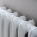 an old vintage metal white heating battery at home apartment
