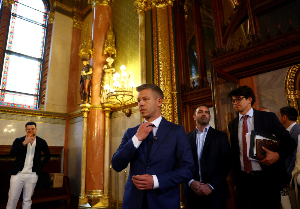 Hungary’s election winner Magyar adjusts his tie after talks between parties on preparations for the first session of the Parliament in Budapest,