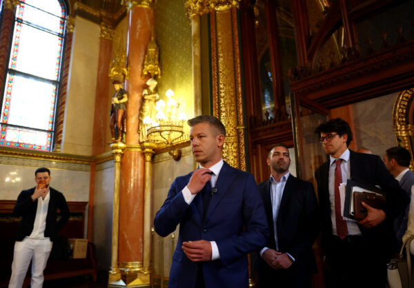 Hungary’s election winner Magyar adjusts his tie after talks between parties on preparations for the first session of the Parliament in Budapest,