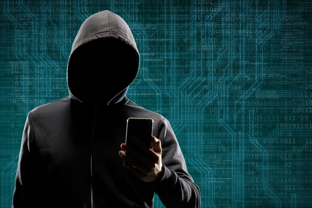 hooded-person-holding-phone-against-a-binary-code-2026-03-26-06-06-12-utc