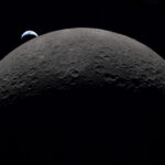 FILE PHOTO: A view of Earth, partially hidden by the Moon, photographed through the Orion spacecraft window