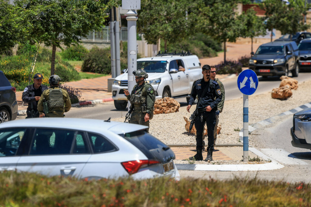 Israeli emergency services work at the scene of what Israeli police say was a series of shooting attacks in central Israel