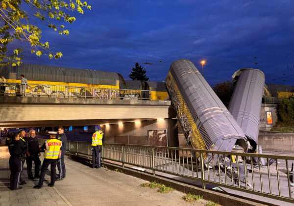 Two cars of a freight train derailed after a collision and fell off a bridge in Munich