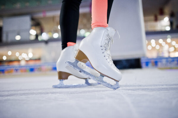 Figure skater woman at ice skating rink.