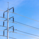 Electric pole and blue sky. Power and energy. Three-phase electr