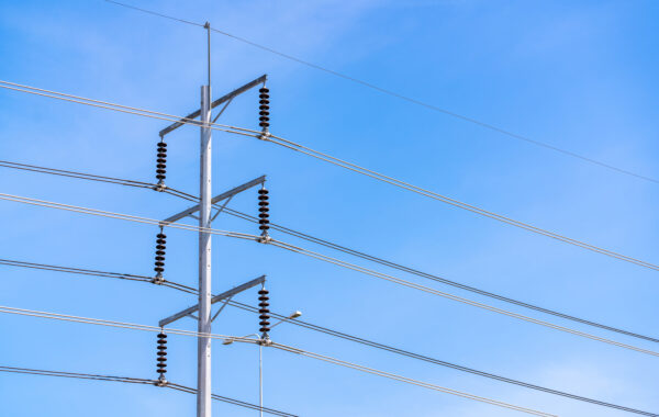 Electric pole and blue sky. Power and energy. Three-phase electr