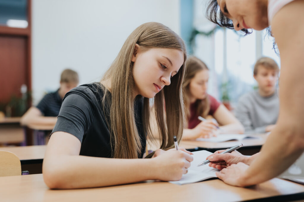 Teenage girl sitting at the table during math class at school