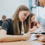 Teenage girl sitting at the table during math class at school