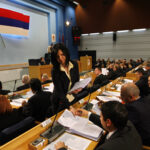 Documents are given to members of the Bosnia’s Serb Republic parliament at the beginning of its special session after protests in Banja Luka