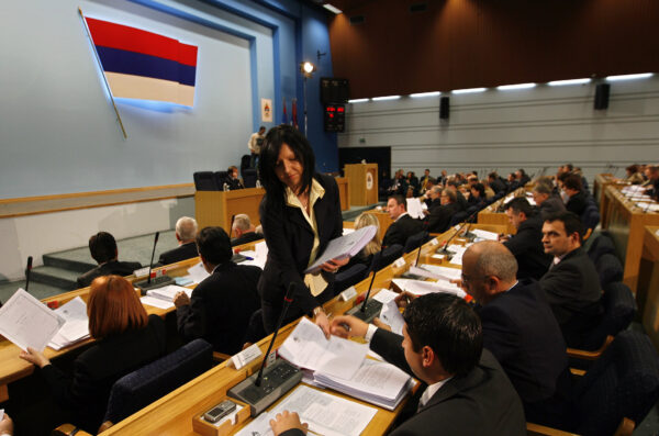 Documents are given to members of the Bosnia’s Serb Republic parliament at the beginning of its special session after protests in Banja Luka