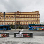 A woman uses her mobile phone in front of the Federal Security Service in Moscow