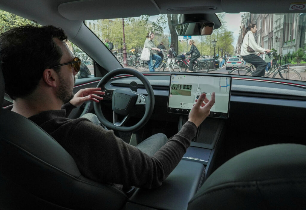 FILE PHOTO: Tesla enthusiast Kees Roelandschap drives around hands-free with his electric car in the city of Amsterdam