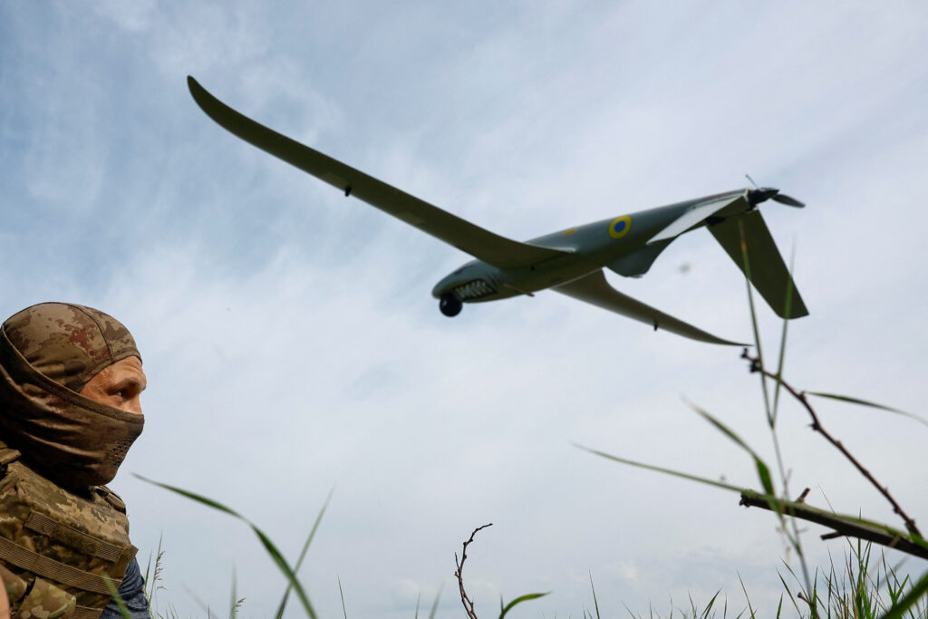 Ukrainian service member looks at a Shark reconnaissance drone as it launches from a position near a front line in Southern Ukraine