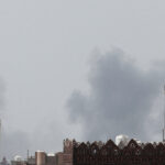 Smoke rises after an airstrike hit the Sanaa International Airport