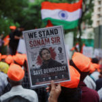 FILE PHOTO: A supporter of the Cockroach Janta Party (CJP) holds a poster of Sonam Wangchuk after authorities moved him to a hospital during his hunger strike, during a protest demanding the resignation of Indian Education Minister Dharmendra Pradhan, in M