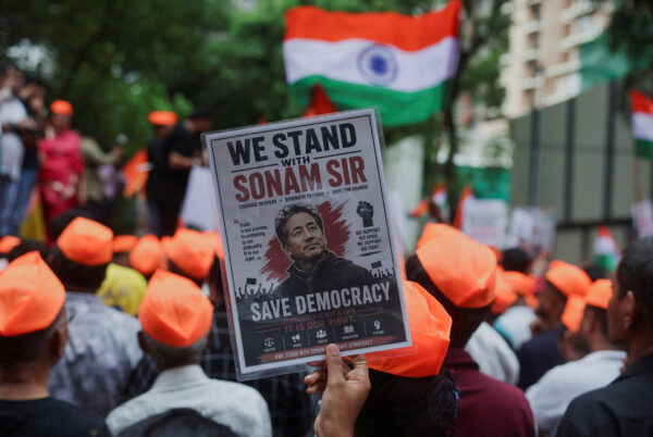 FILE PHOTO: A supporter of the Cockroach Janta Party (CJP) holds a poster of Sonam Wangchuk after authorities moved him to a hospital during his hunger strike, during a protest demanding the resignation of Indian Education Minister Dharmendra Pradhan, in M