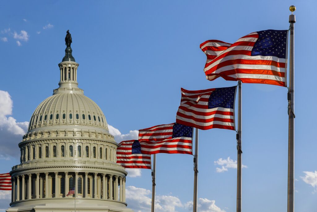 Capitol building in Washington, DC with United States flags