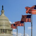 Capitol building in Washington, DC with United States flags