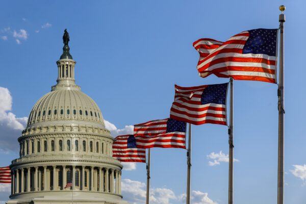 Capitol building in Washington, DC with United States flags
