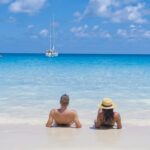 Anse Lazio Praslin Seychelles, young couple men and woman on a tropical beach during a luxury vacation in the Seychelles. Tropical beach Anse Lazio Praslin Seychelles