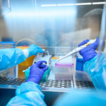 Infectious disease specialists analyze biomaterial in a sterile room