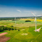 Wind turbines on green field in Poland, view from above