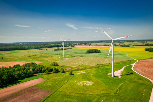 Wind turbines on green field in Poland, view from above