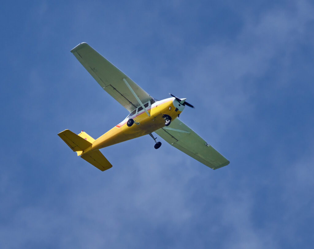 yellow-airplane-flying-against-the-blue-sky-2026-03-26-01-33-26-utc