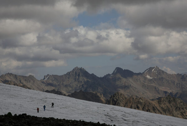 FILE PHOTO: People walk on the slope of Mount Elbrus in the Republic of Kabardino-Balkaria