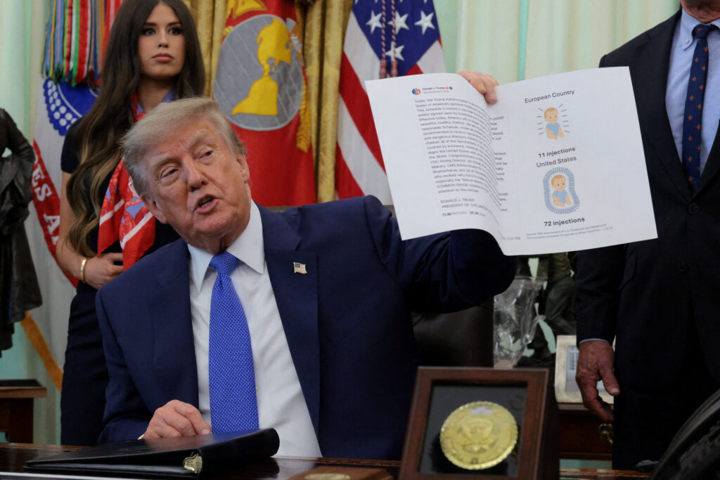 U.S. President Donald Trump signs an executive order in the Oval Office at the White House in Washington