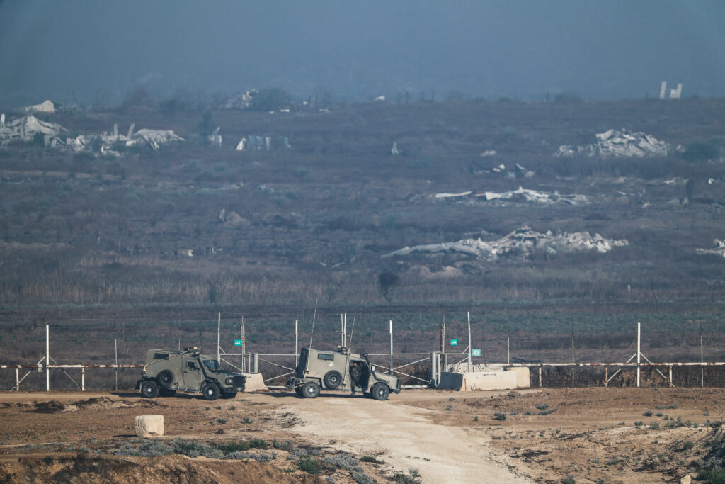 Israeli military vehicles near the Israel-Gaza border fence on the Israeli side of the border