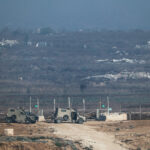 Israeli military vehicles near the Israel-Gaza border fence on the Israeli side of the border