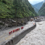 Firefighters conduct search and rescue operations after a mudslide in Gyirong county