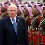 FILE PHOTO: Norway’s King Harald V reviews an honor guard at the Royal Palace in Amman