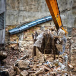 Excavator breaks old house. Freeing up space for the constructio