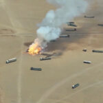 Smoke rises from trucks, near Al-Wadiah