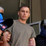 A Russian citizen believed to be involved in a thwarted sabotage operation coordinated by Russia on Romanian territory is escorted outside the DIICOT headquarters, in Bucharest