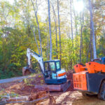 An uprooted tree is uprooted by a tractor during construction, preparing land for building