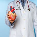 doctor-holds-heart-model-for-medical-presentation-2026-03-09-23-02-14-utc